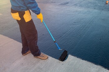 Roofer applying roof coating in Canyon, CA